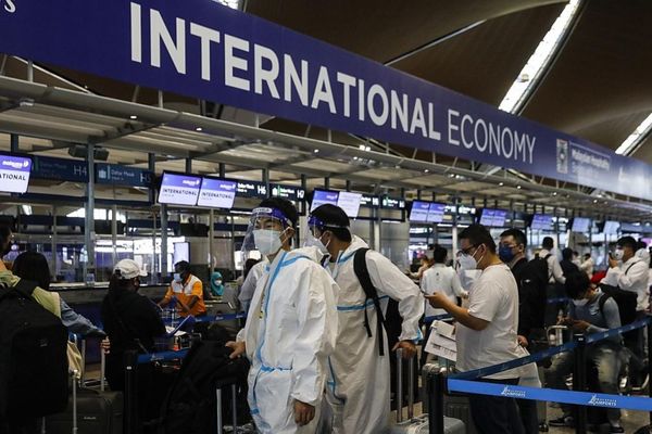 Travellers wearing PPEs wait their turn at KLIA on 29 November.