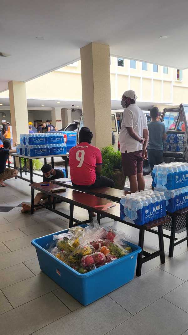 Volunteers taking a break as food boxes are being loaded to be sent out.