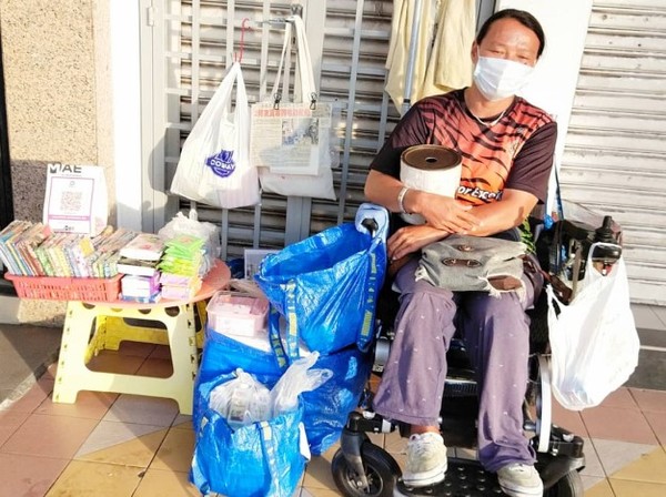 A 2020 photo of Koh in her wheelchair, selling tissues and covers.