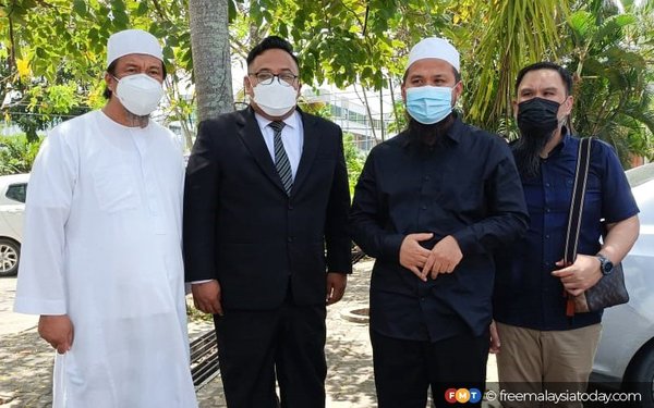 Ebit Lew (second from right) with his lawyer Zairi Zainal Abidin (second from left) and other friends in Tenom, Sabah, yesterday, 18 February.