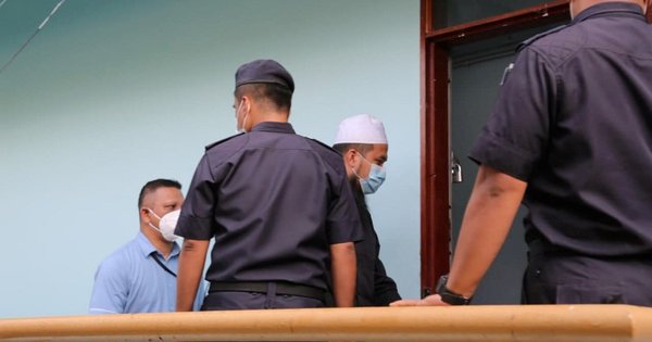 Ebit Irawan Ibrahim Lew was seen being escorted at Tenom magistrate's court yesterday.