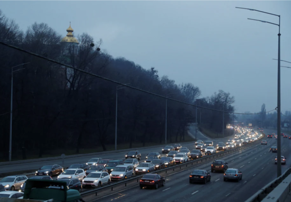 Cars drive away from Kyiv on 24 February after Russian President Vladimir Putin launched a full-scale military operation.