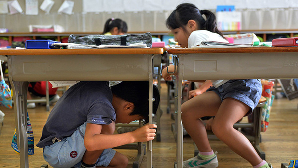 Children in Japan learn to duck under a table or desk to avoid falling objects in the event of an earthquake.