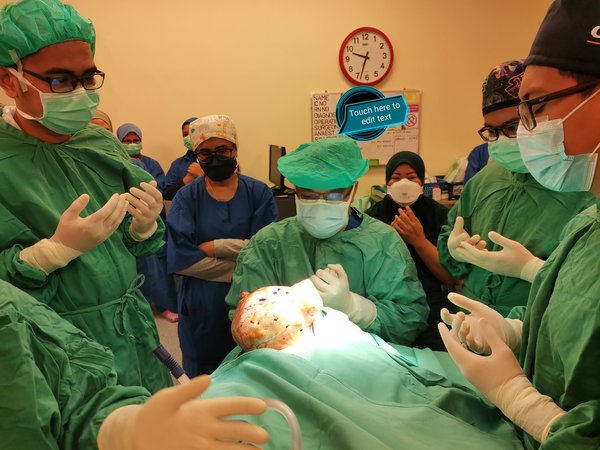 The surgical team reciting a prayer before starting the procedure.