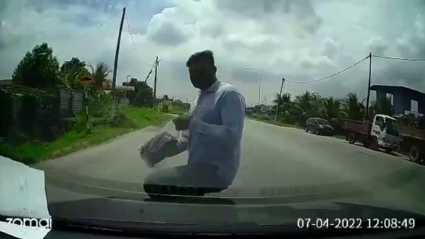 The man is seen on the dashcam footage suddenly crossing the road and flinging himself into the moving car's windshield.