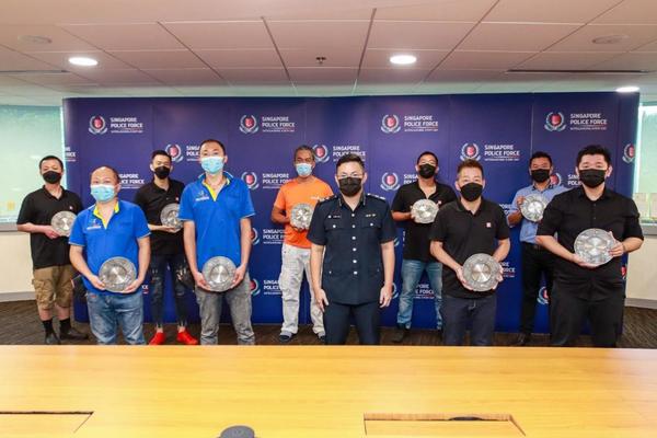 Commander of the central police division Jeremy Ang (middle, front row) and the 10 award recipients.